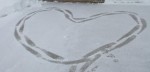 footprints in the snow in the shape of heart